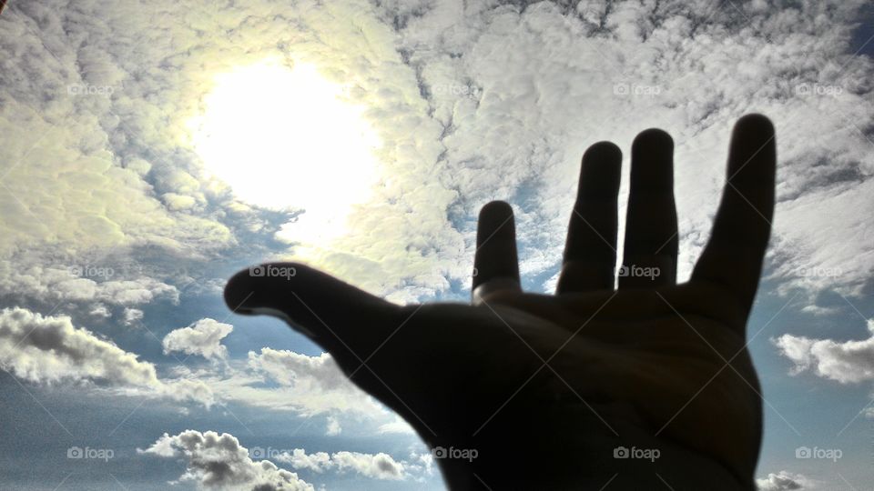 hand to sun
