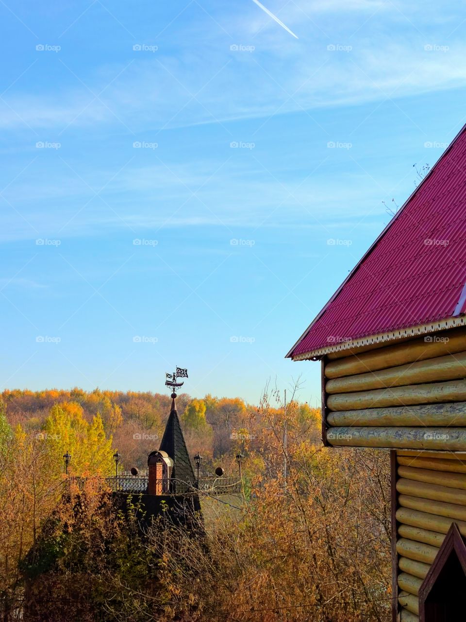 Autumn.  Autumn colorful trees.  A wooden tower is visible among the trees