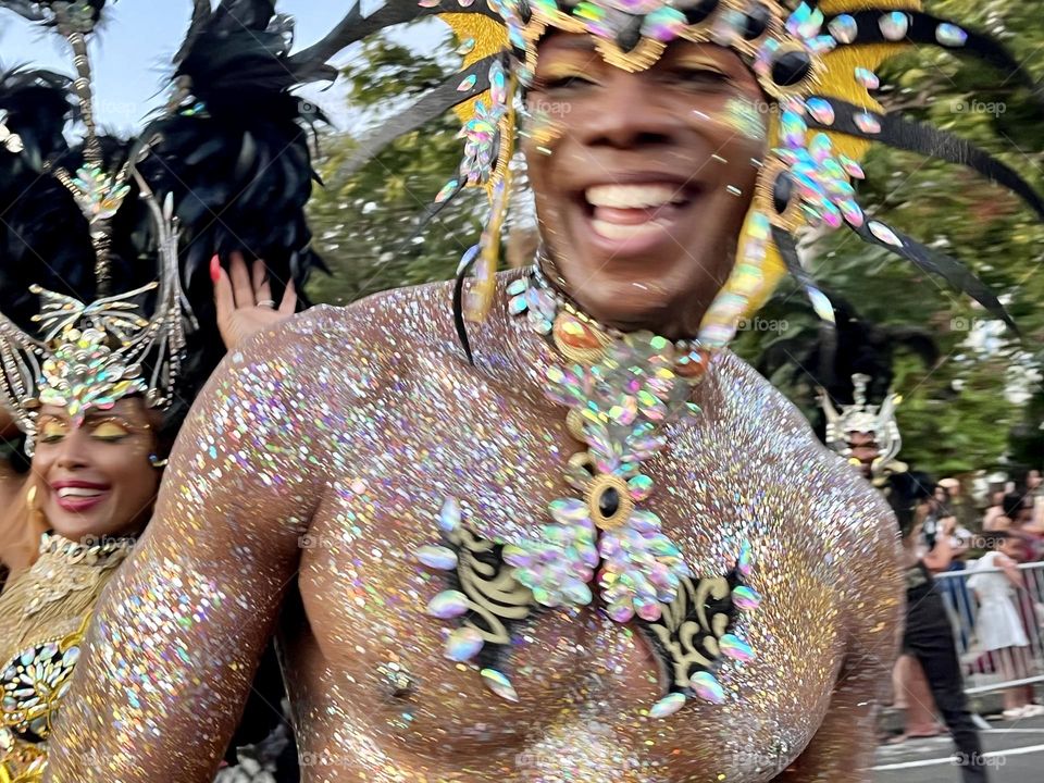 Young man in carnival costume who laughs during the Guadeloupe carnival parade