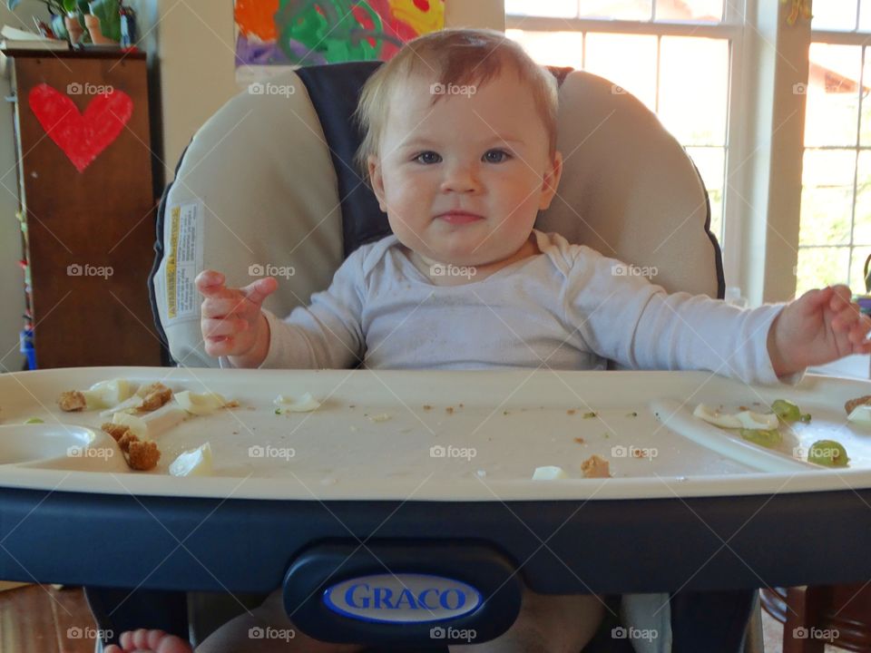 Baby Eating In A Highchair