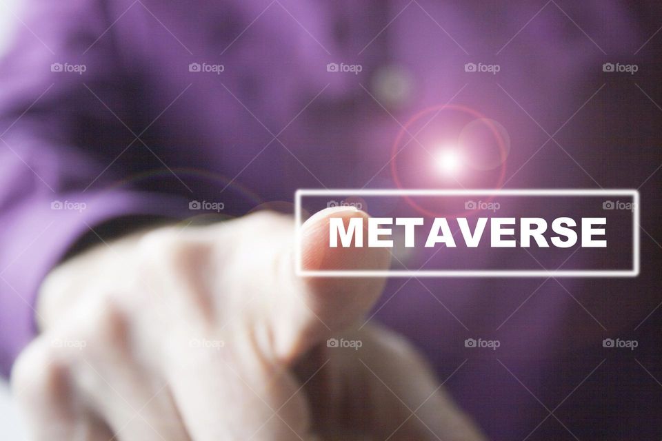 Man hand pressing "Metaverse" button