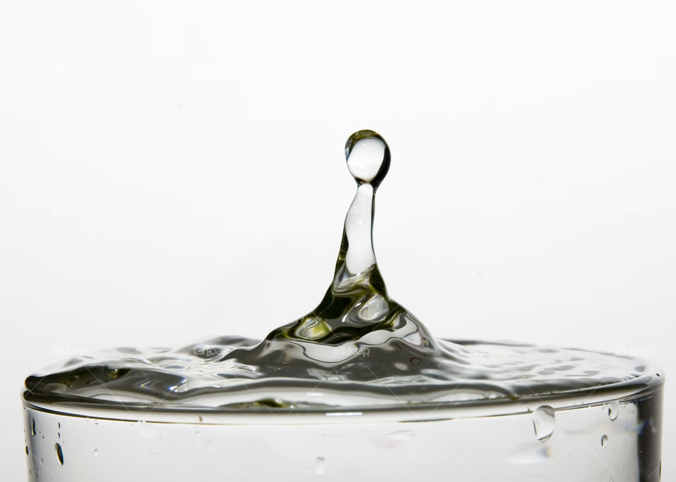 Close-up of drop splashing in drinking glass