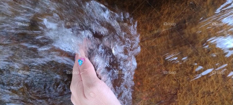 water running between the fingers