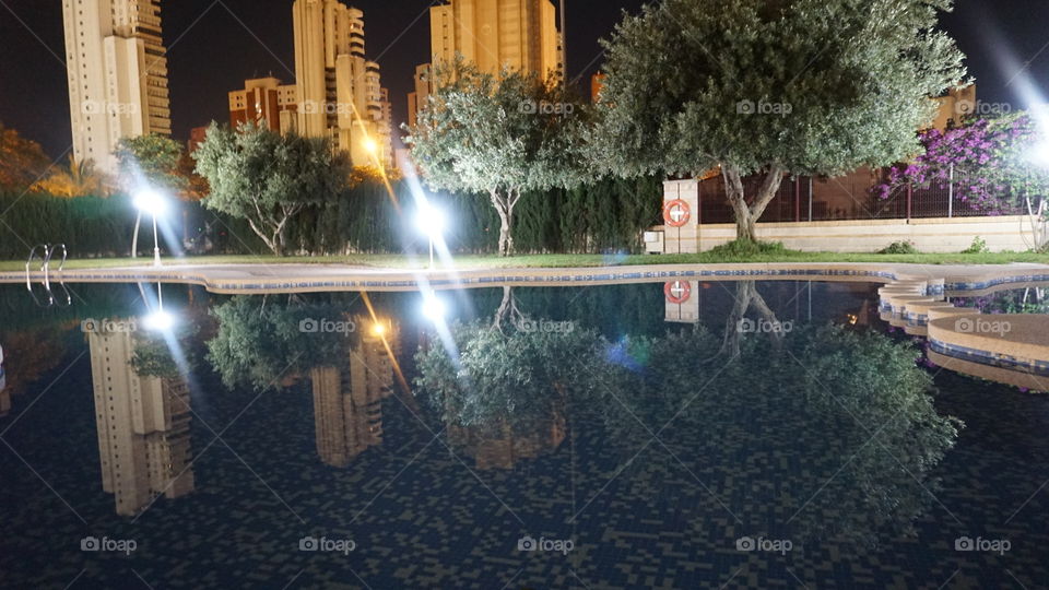 Swimmingpool#water#trees#reflect#buildings#lights#night