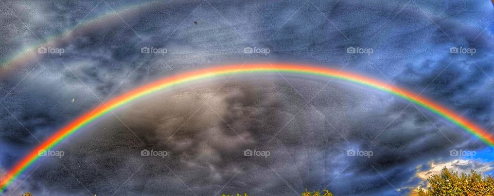 beautiful rainbow in dark sky