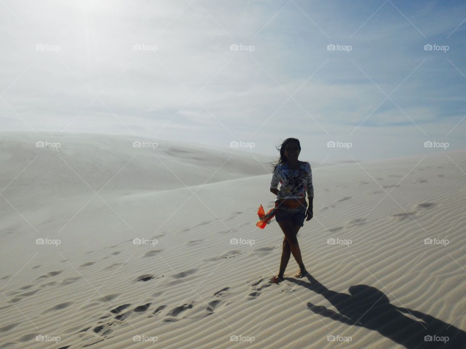 Pretty woman standing on sand