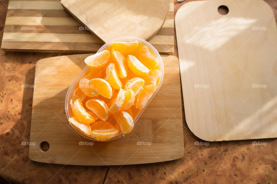 Delicious orange jelly with tangerine slices in a container and jelly worms.