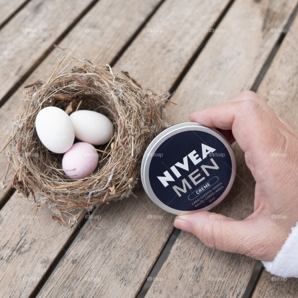 Nest with Easter eggs and someone handling a Nivea tin for men
