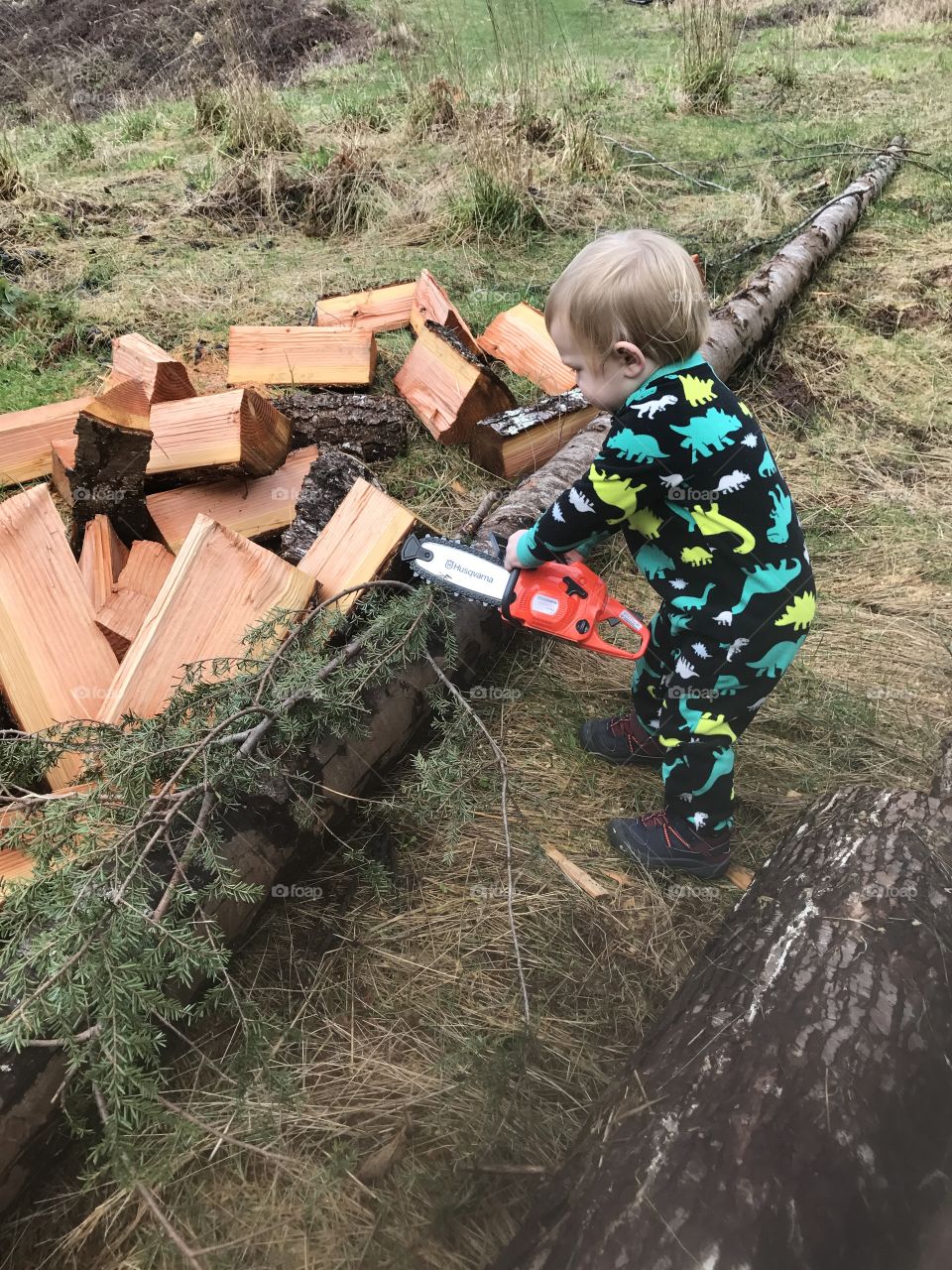 Close-up of boy with chainsaw