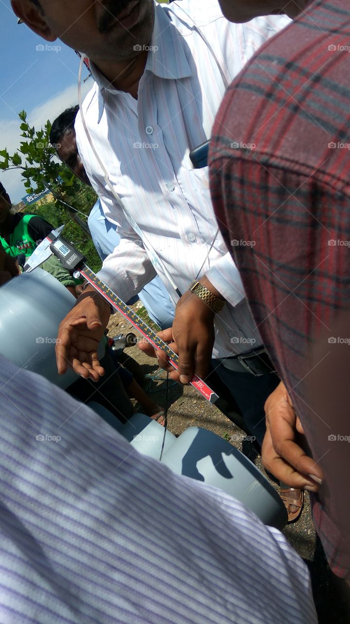 people's working in hands they're doing measurements