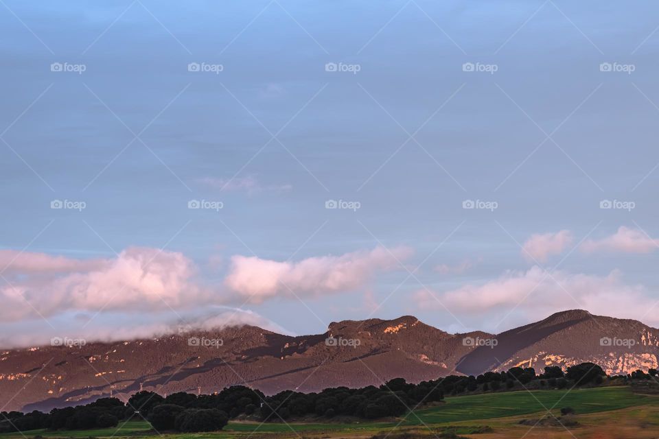 beautiful mountain landscape with green grass against blue sky