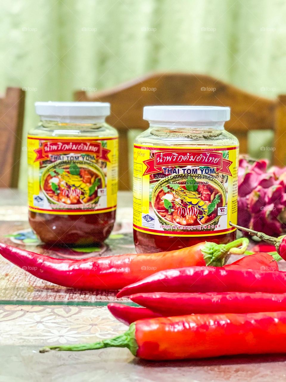 Product photography- Tom Yum paste in a bottle and some ingredients in front of the bottle. Thailand product
