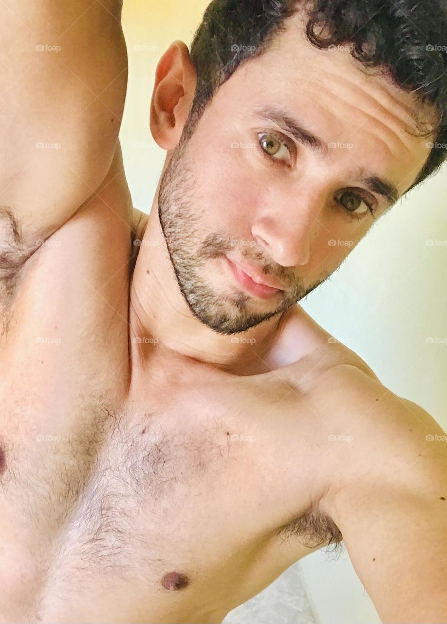 strong handsome man showing his arm and chest