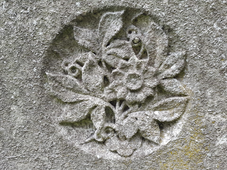 walking in an old graveyard can be a beautiful experience.  Times gone by all with a story. This one told with an old grey stone and a floral engraving