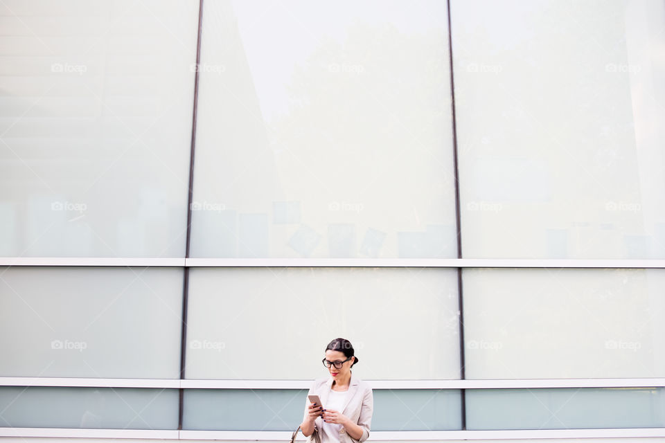 Business woman looking in her smartphone