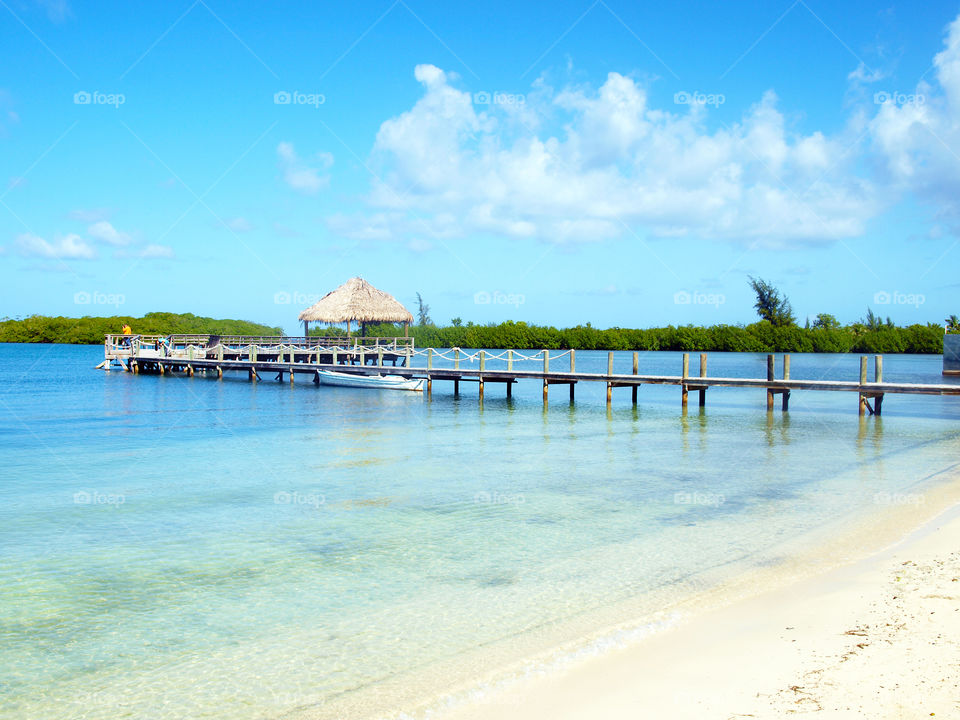 Beach with jetty and overwater bungalow