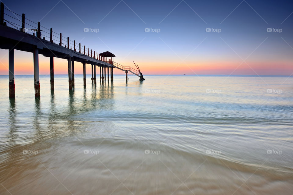 Sunset at the beach over the long pier