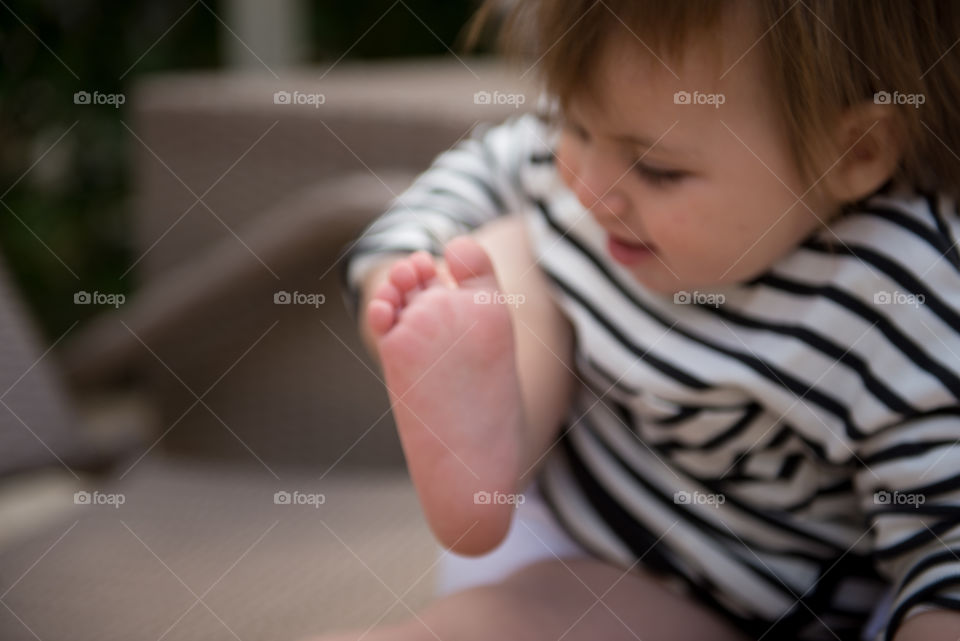 baby trying to smell her feet