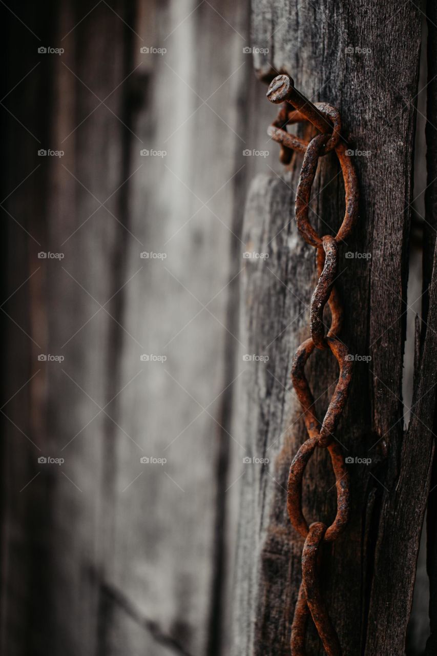 old wooden door with a rusty chain