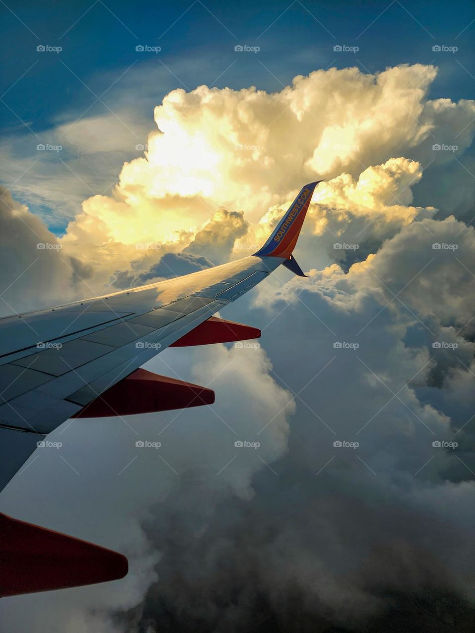 A massive cloud formation featuring strong rain and turbulence is dodged by a Southwest Airlines 737 jet