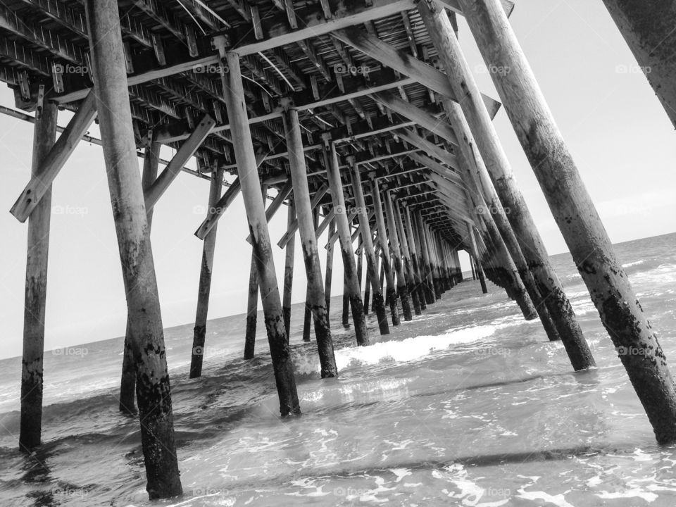 Pier. Black and white image under a fishing pier.