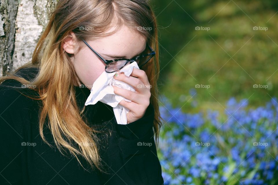 Close-up of a girl blowing her nose