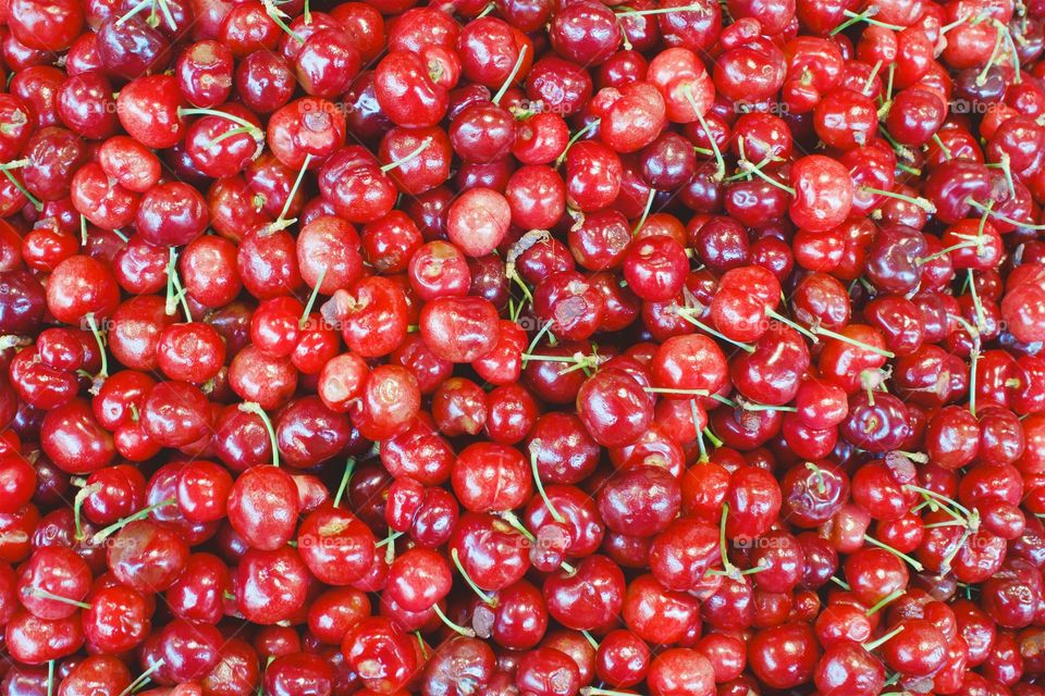 A heap of fresh red cherries for sale outside a Chinatown grocery store in New York City.