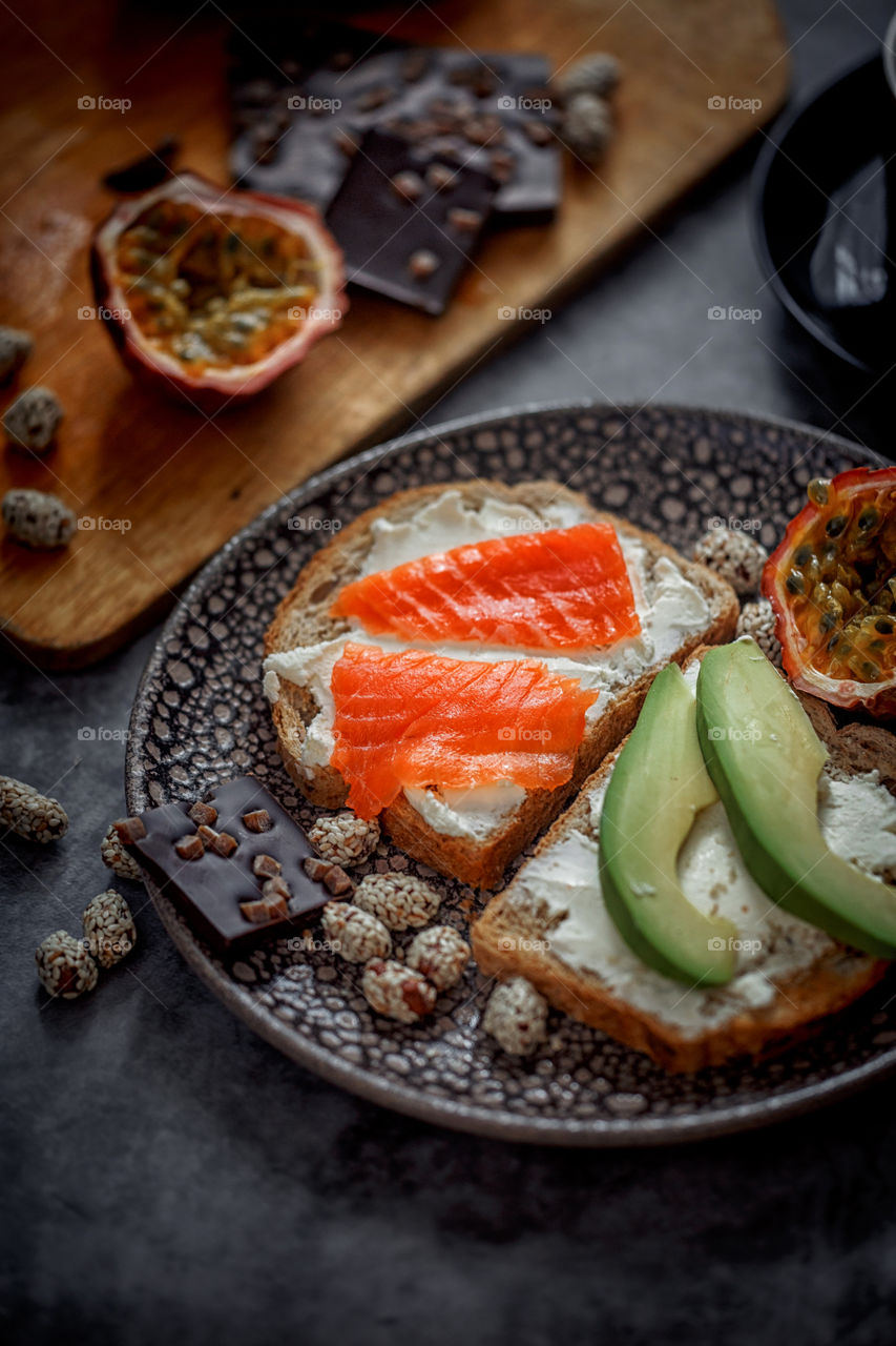 Dietary sandwiches of grain toasts with cream cheese, fish and avocado 