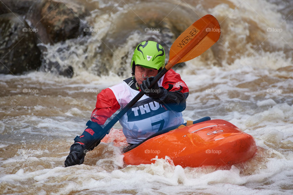 Helsinki, Finland -  April 15, 2018: Unidentified racer at the annual Icebreak 2018 whitewater kayaking competition at the Vanhankaupunginkoski rapids in Helsinki, Finland.