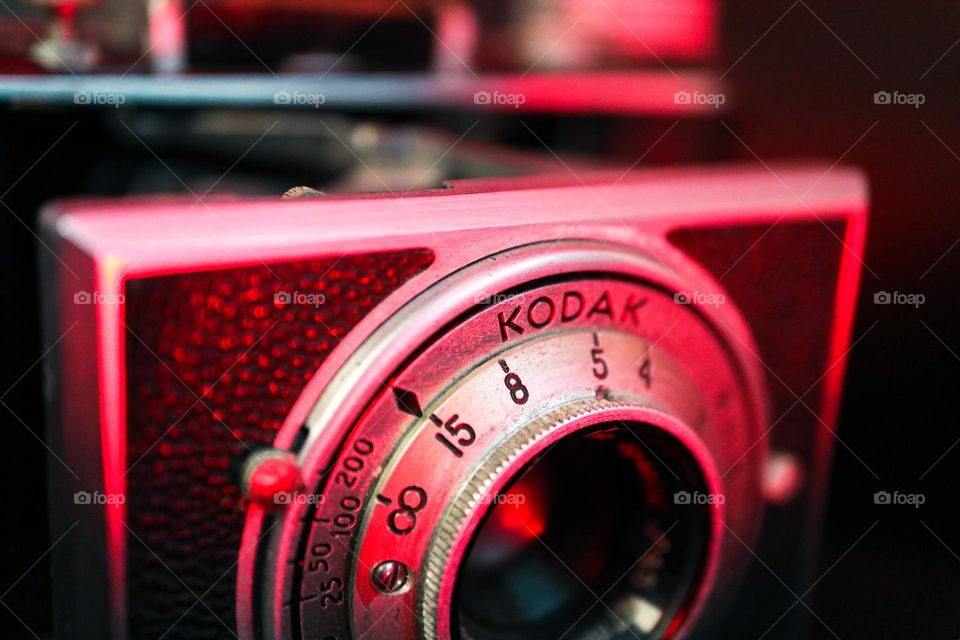 Closeup of a vintage Kodak bantam land camera, red mood lighting macro 