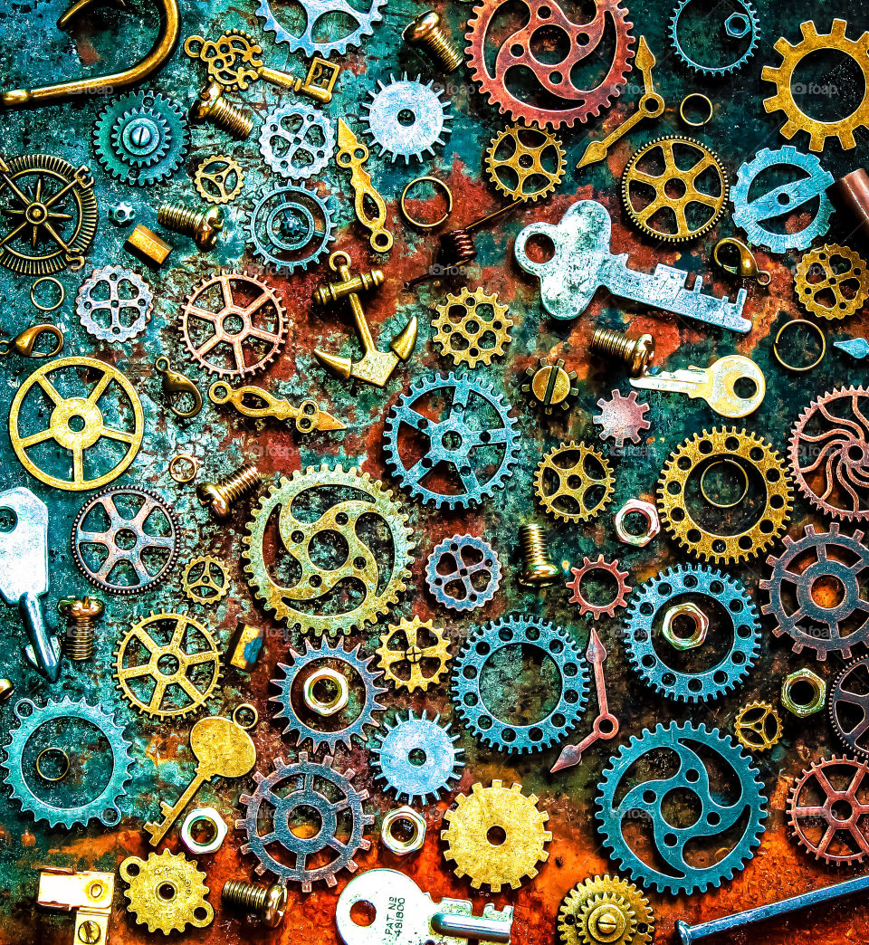 An above view at assorted pieces of metal places on a rusty metal surface