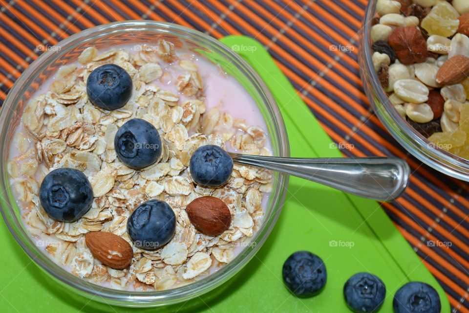 oat meal with nuts and berries healthy tasty food table background