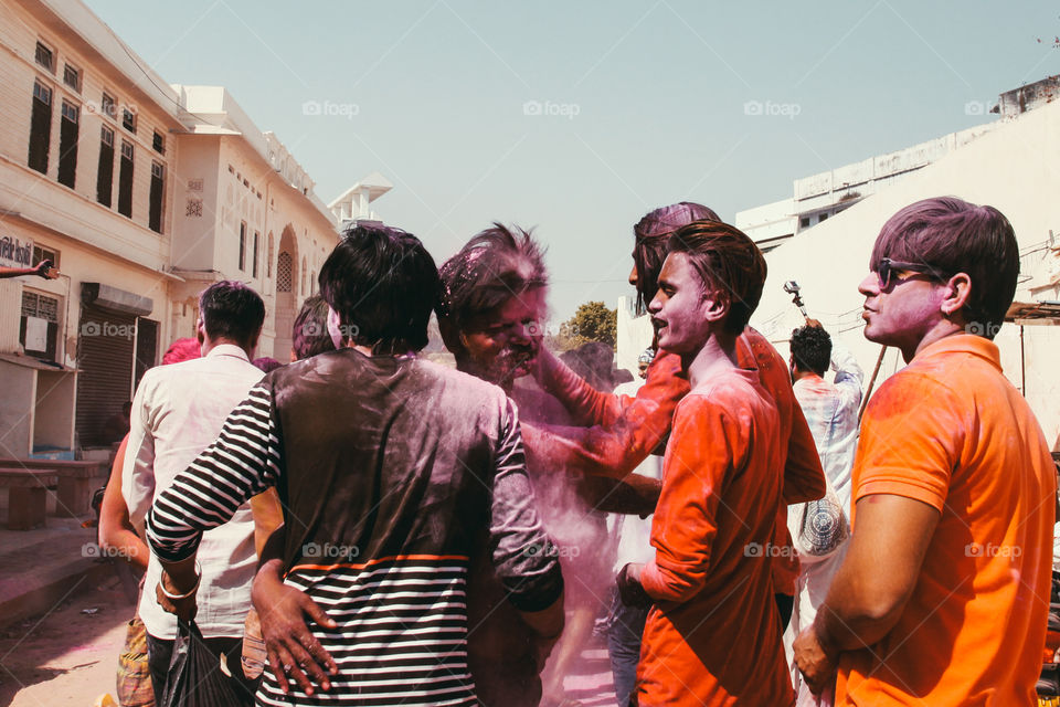 A man has pink powder thrown in his face by his friends at Holi festival in Pushkar, India.