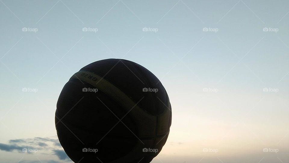  A ball hugging the sunset.