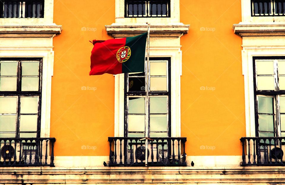 The flag of Portugal at a historic building in Lisbon