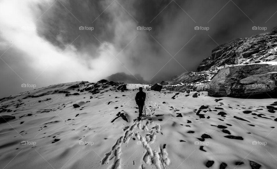 wanderlust trekker going on the snow mountain