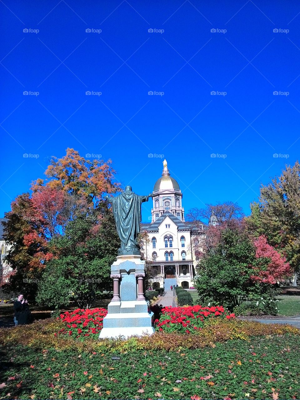 notre dame golden dome. statute in front of the administration building