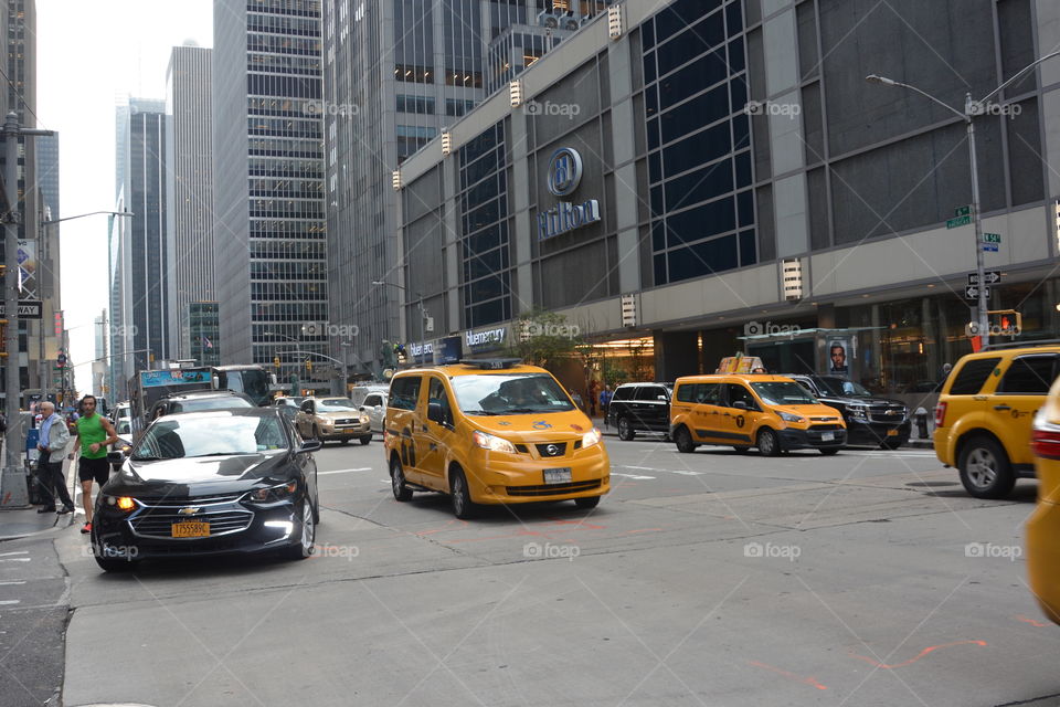 Typical New York City  street with skyscrapers and traffic including yellow taxi's
