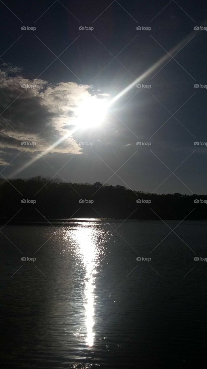 sun setting over the water