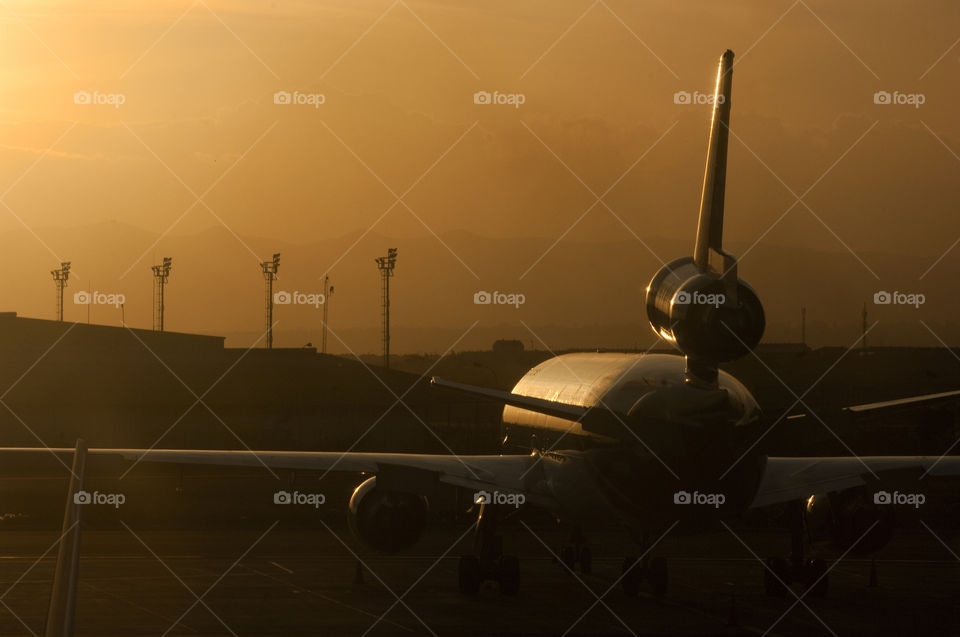Airplane on Kenya International Airport at sunset.