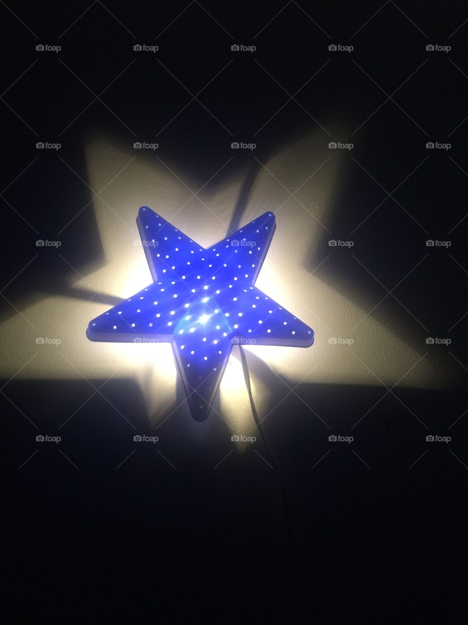 Light on a wall in form of a star