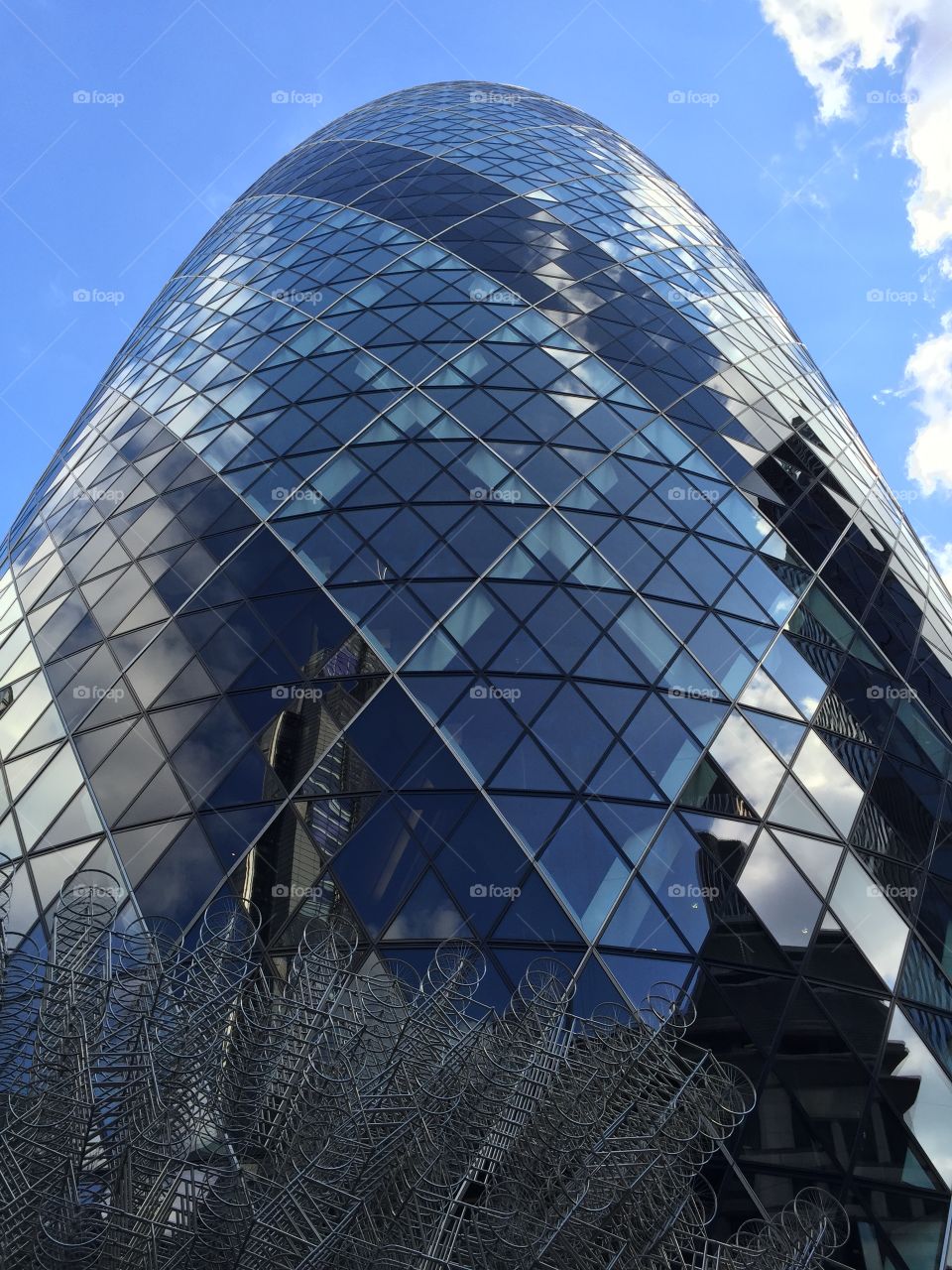A skyscraper full of windows . A skyscraper with all glass windows in London 