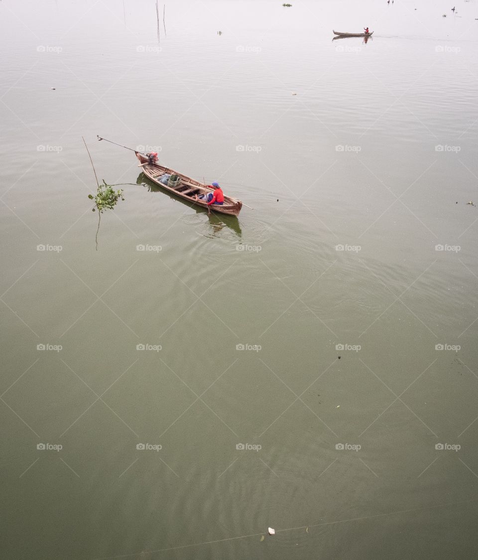 Myanmar guide tourists in boat to see local life at U bein bridge , the most longest wooden bridge in the world
