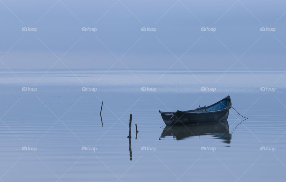 black fishing boat on lake
