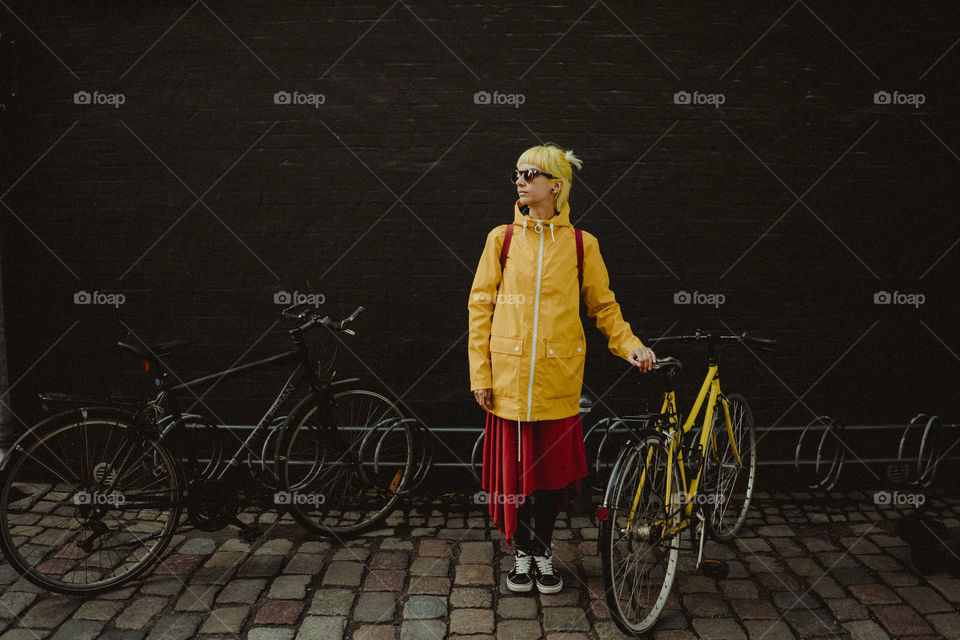 Girl with yellow hair and her yellow bicycle