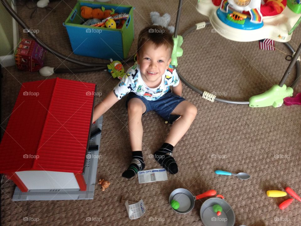 Boy playing with toys at home 