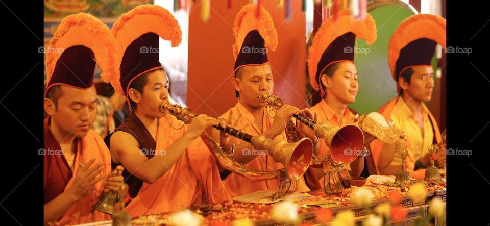 Monks are performing ritual instruments in puja
