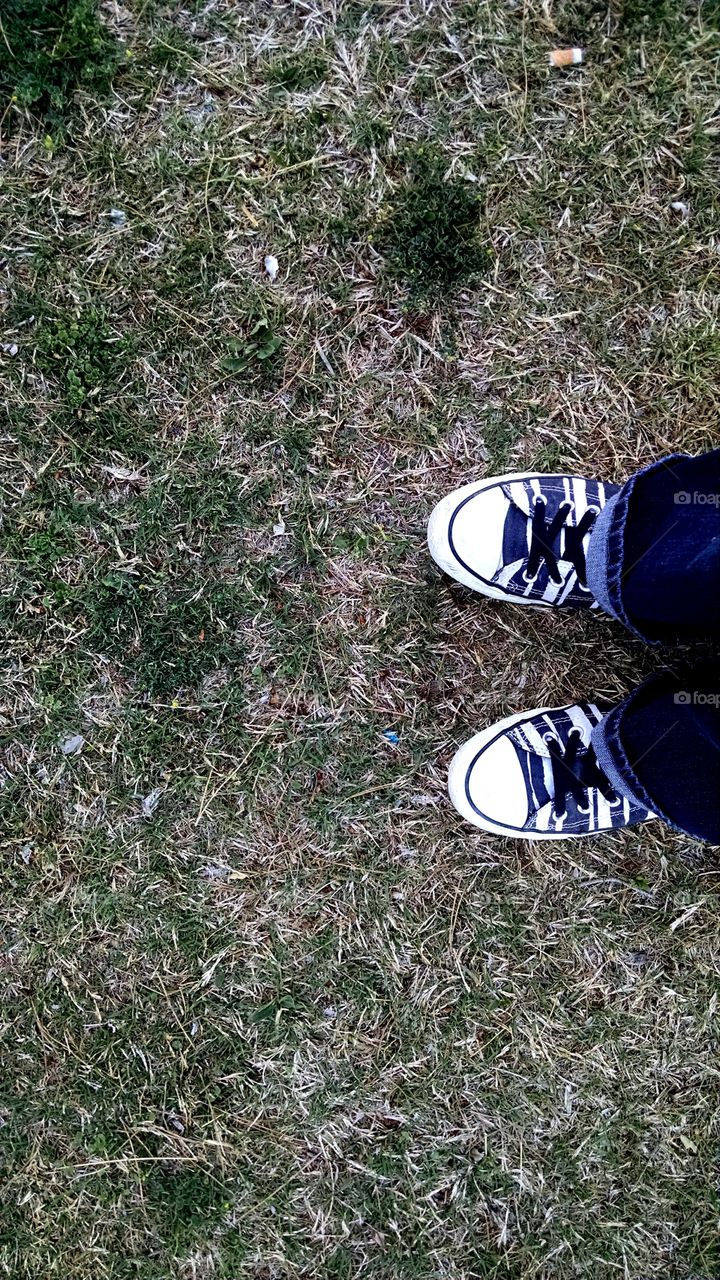 Shoes Stepping On The Grass