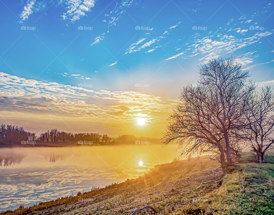 The sun in the clouds on the river Akhtuba