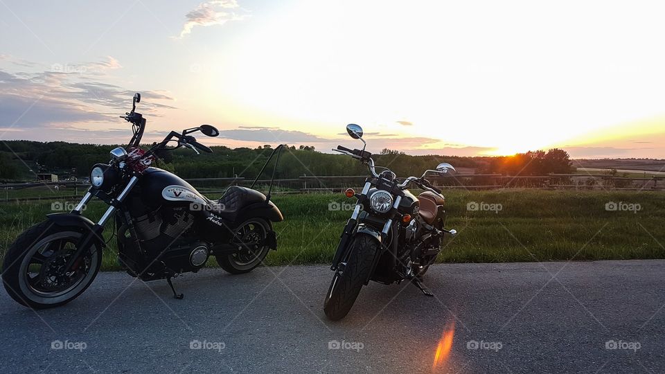 two motorcycles in the sunset